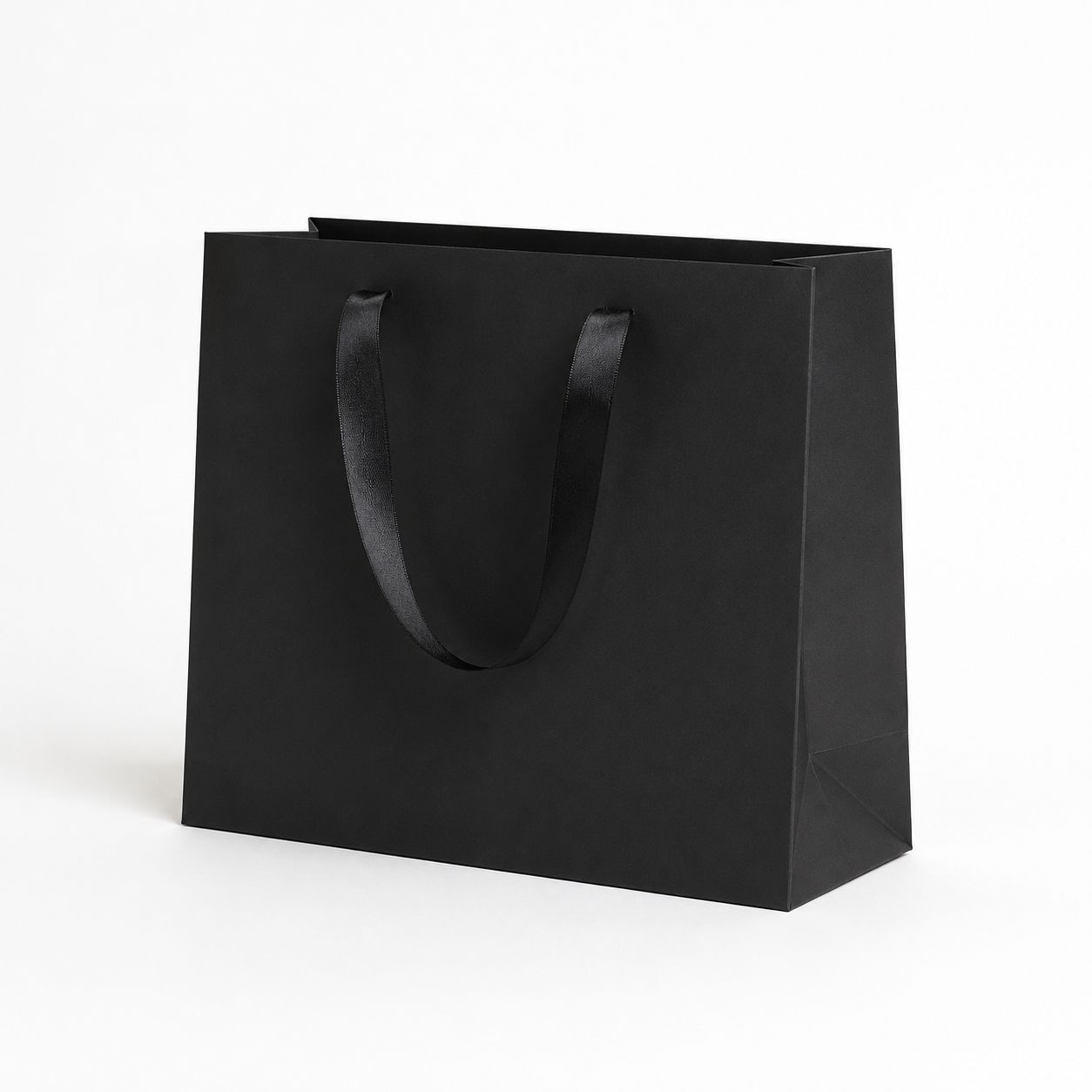 Black gift bag photographed alone on a white background