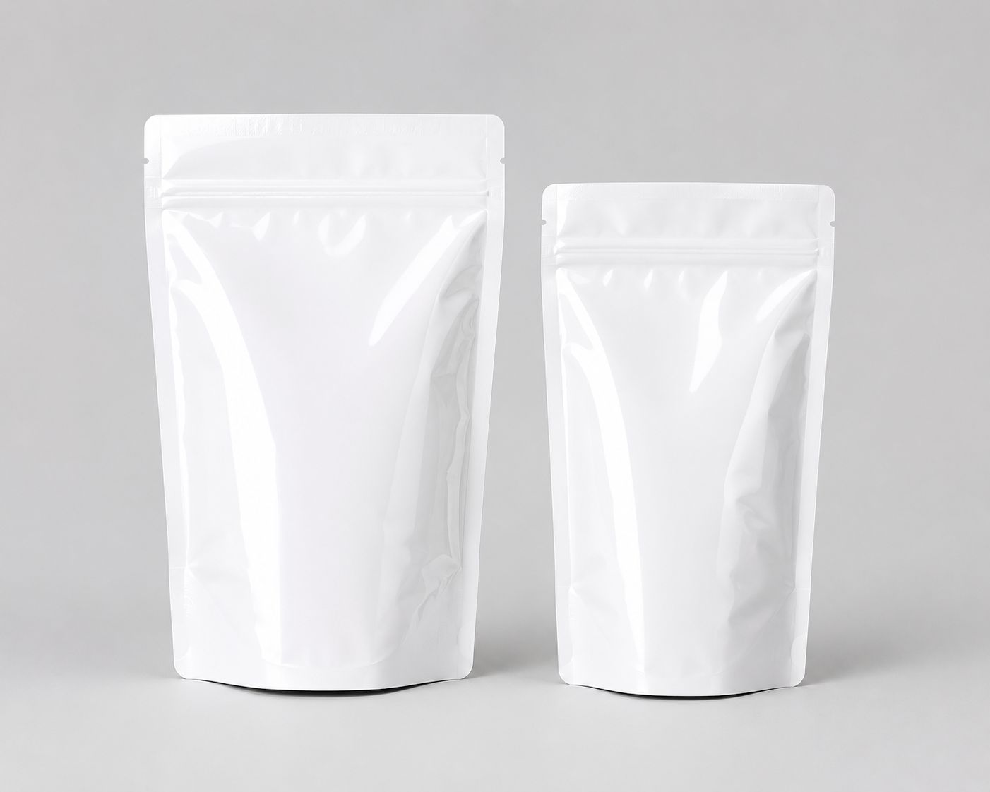 Two plain white stand-up pouches in a clean studio setting